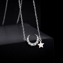 Close-up of the pendant and clasp on the Star and Moon Necklace