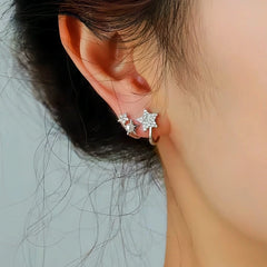 Model showcasing the dangle and style of the Sterling Silver Star And Pearl Studs