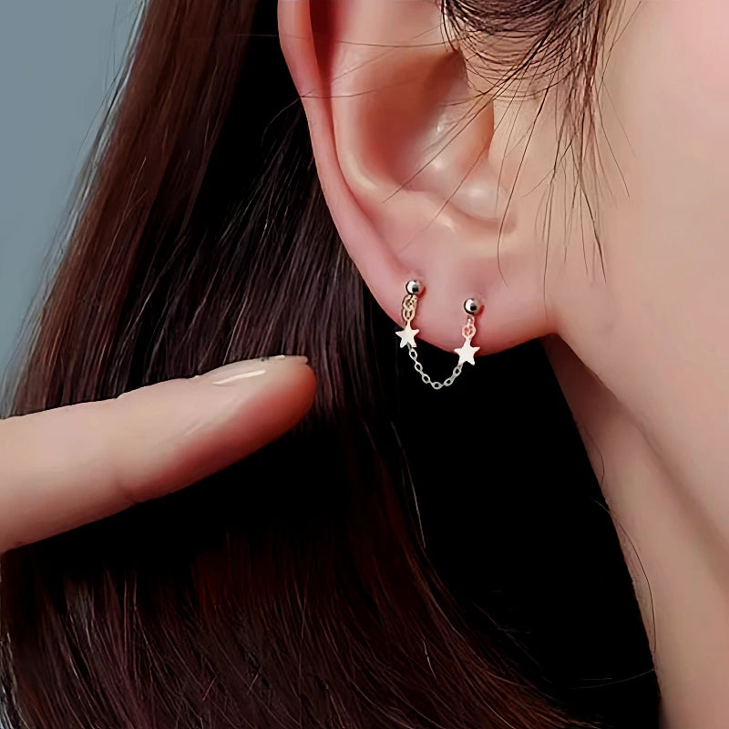 Close-up detail of the sparkling zircons and plating on the Star Dangle Earrings