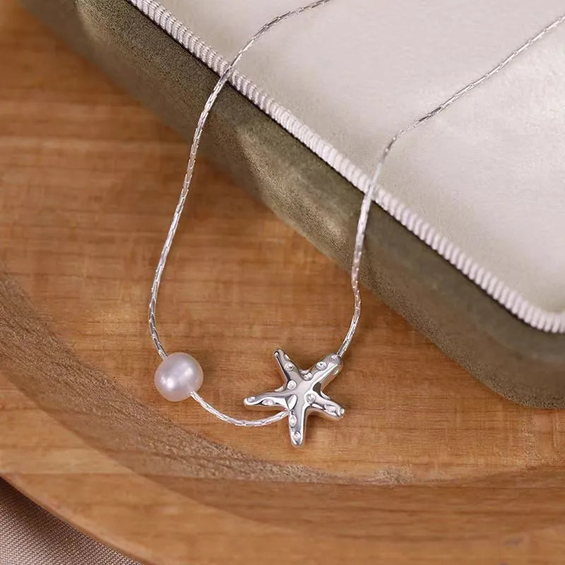 Close-up of the pendant and clasp on the Starfish Pearl Necklace