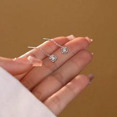 Angled view of the Sterling Silver Sun Threader Earrings