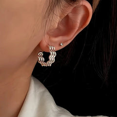 Model showcasing the dangle and style of the Sterling Silver Three-Layer Wave Texture Earrings