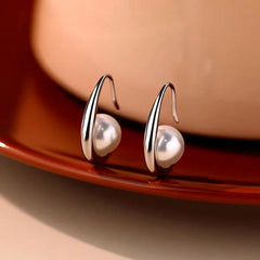 Model showcasing the dangle and style of the Sterling Silver Water Drop Pearl Earrings
