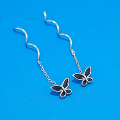 Model showcasing the dangle and style of the Sterling Silver Wavy Butterfly Threader Earrings