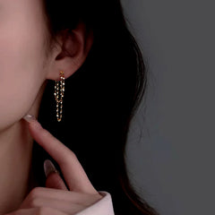 Model showcasing the dangle and style of the Sterling Silver Wavy Chain Earrings