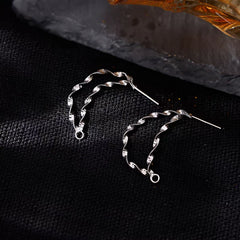 Close-up detail of the sparkling zircons and plating on the Wavy Chain Earrings