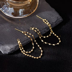 Angled view of the Sterling Silver Wavy Chain Earrings