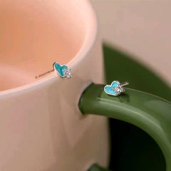 Angled view of the Sterling Silver Zircon Blue Heart-Design Stud Earrings