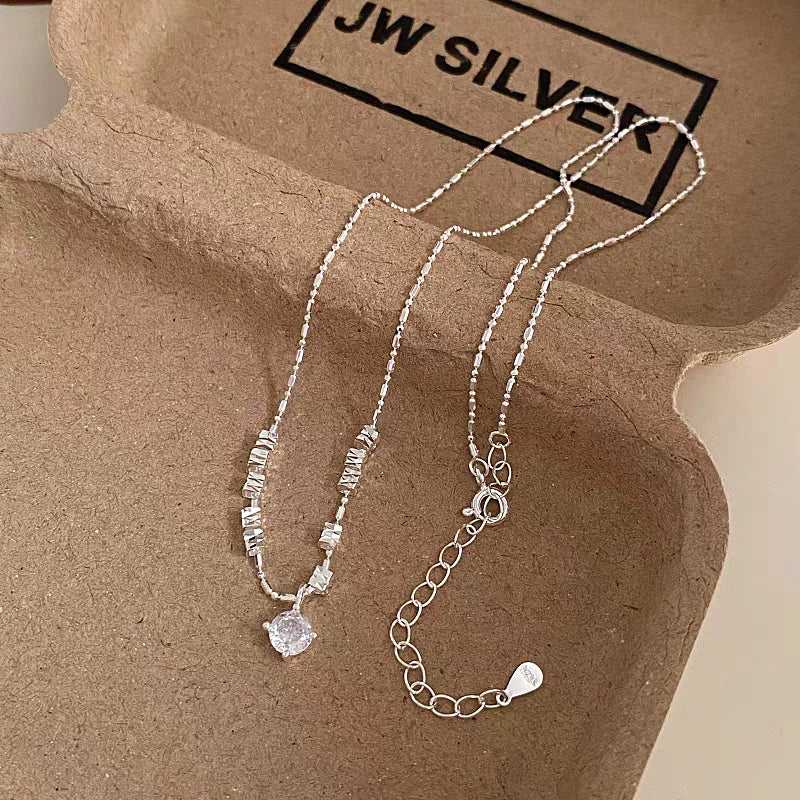 Close-up of the pendant and clasp on the Crushed Silver Necklace