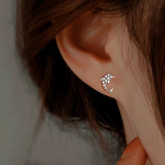 Model showcasing the dangle and style of the Sterling Silver Zircon Dolphin Studs