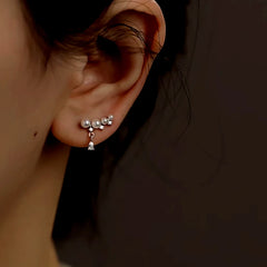 Close-up detail of the sparkling zircons and plating on the Pearl Crawler Earrings