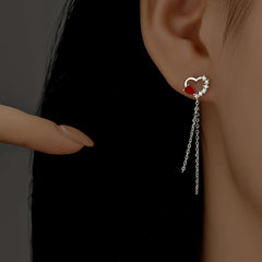 Close-up detail of the sparkling zircons and plating on the Red Heart Tassel Earrings