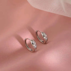 Model showcasing the dangle and style of the Sterling Silver Zircon Small Sun Earrings