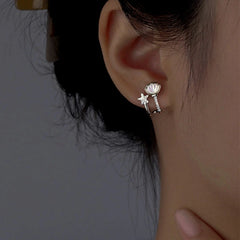 Model showcasing the dangle and style of the Sterling Silver Zircon Starfish Shell Stud Earrings