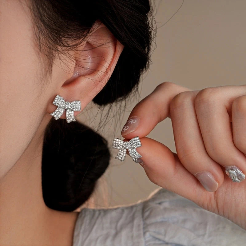 Model showcasing the dangle and style of the 14K Gold-Plated Elegant Zircon Diamond Butterfly And Bow Earrings