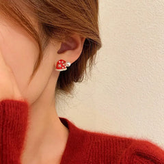 Angled view of the Silver Post Christmas Hat & Gloves Stud Earrings