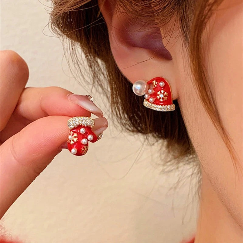 Model showcasing the dangle and style of the Silver Post Christmas Hat & Gloves Stud Earrings