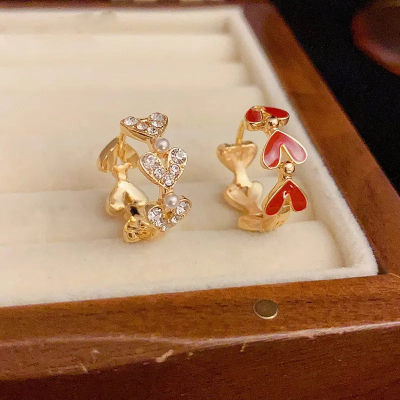 Model showcasing the dangle and style of the 14K Gold-Plated Elegant Heart-Shaped Oil-Drop Earrings