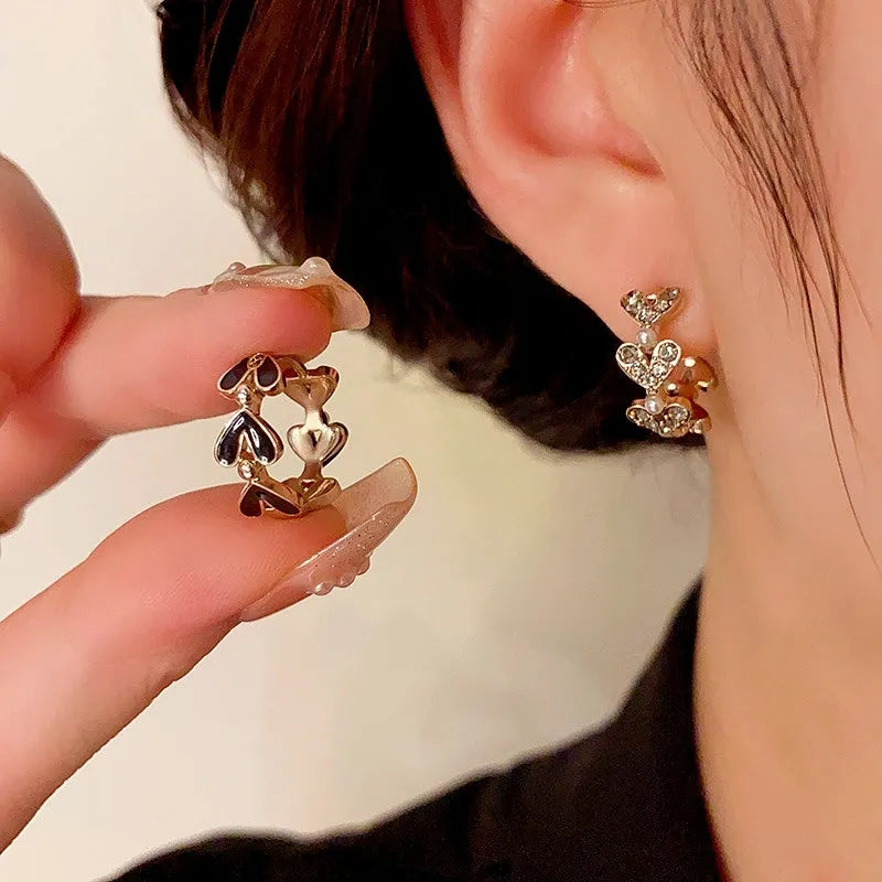 Close-up detail of the sparkling zircons and plating on the Heart Hoop Earrings