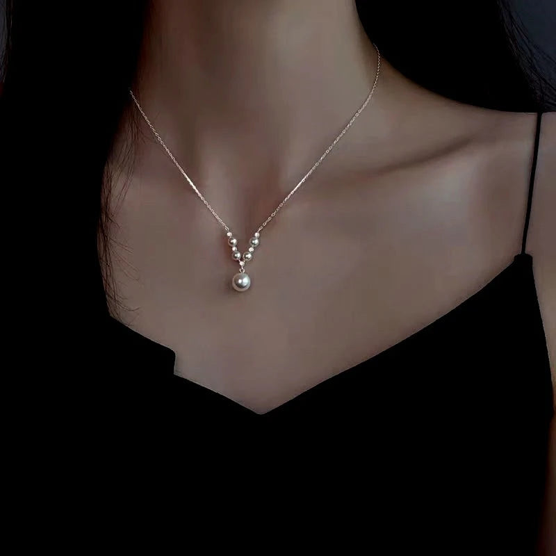 Close-up of the pendant and clasp on the V-Shaped Pearl Necklace