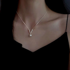 Close-up of the pendant and clasp on the V-Shaped Pearl Necklace