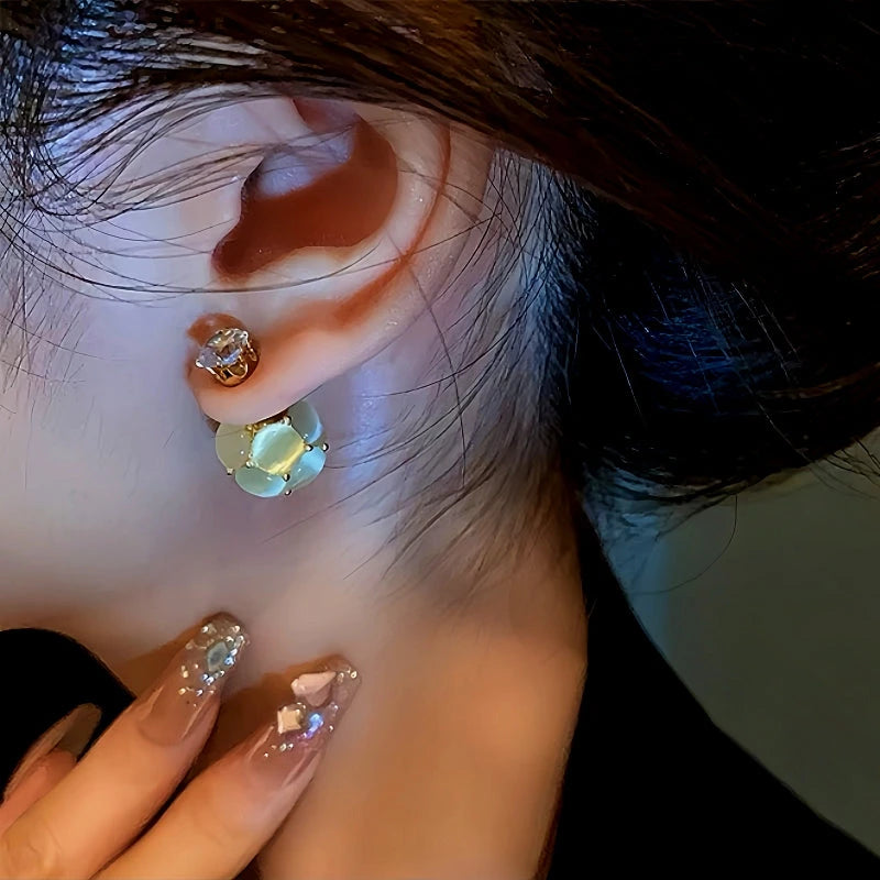 Model showcasing the dangle and style of the 14K Gold-Plated Diamond Cat's Eye Ball Jacket Earrings