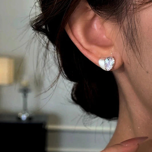 Model showcasing the dangle and style of the 14K Gold-Plated Elegant Zircon Diamond Heart Stud Earrings