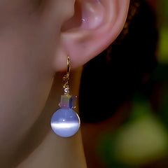 Model showcasing the dangle and style of the 14K Gold-Plated Elegant Zircon Diamond Square Bead Earrings