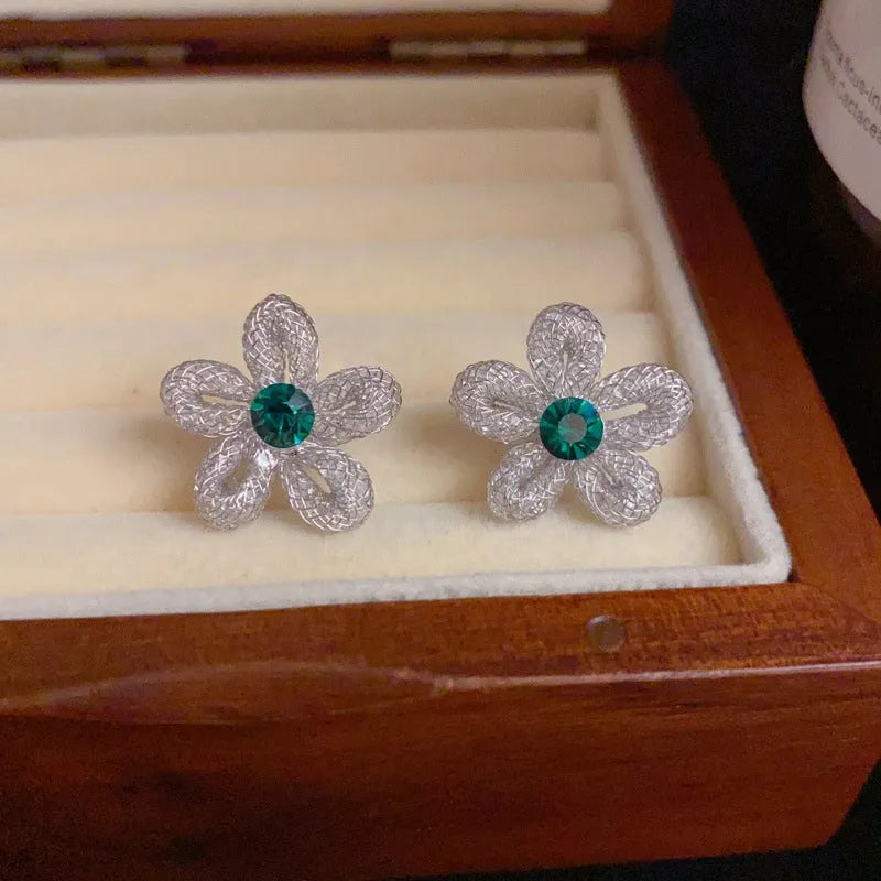 Angled view of the 14K Gold-Plated Elegant Zircon Hollow Flower Stud Earrings