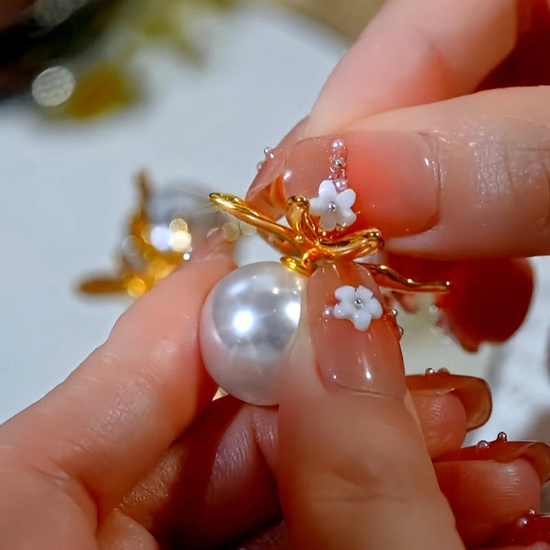 Angled view of the 14K Gold-Plated Luxury Flower Pearl Jacket Earrings