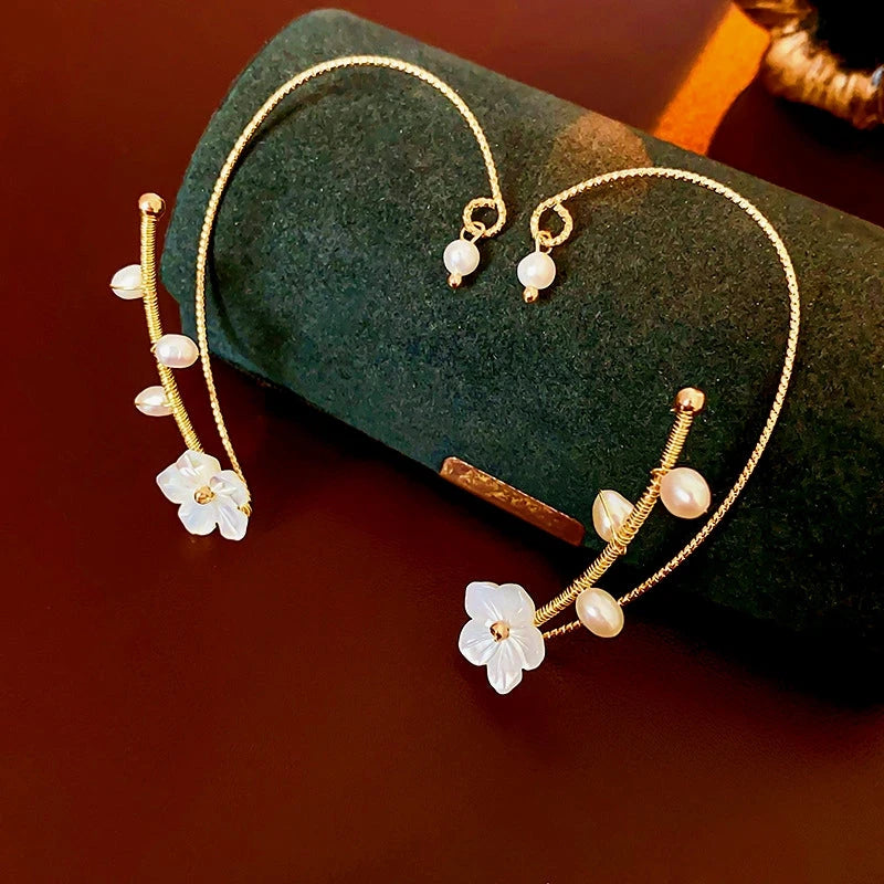 Model showcasing the dangle and style of the 14K Gold-plated Flower Pearl Ear Cuffs ( 1 Pair )