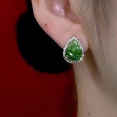 Model showcasing the dangle and style of the 14K Gold-Plated Elegant Green Crystal Water Drop Earrings