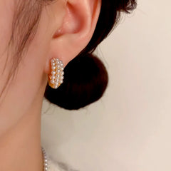 Model showcasing the dangle and style of the 14K Gold-Plated Elegant Pearl C-Shaped Earrings