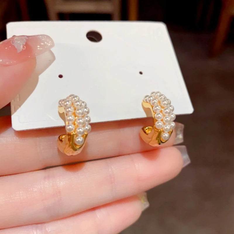 Angled view of the 14K Gold-Plated Elegant Pearl C-Shaped Earrings