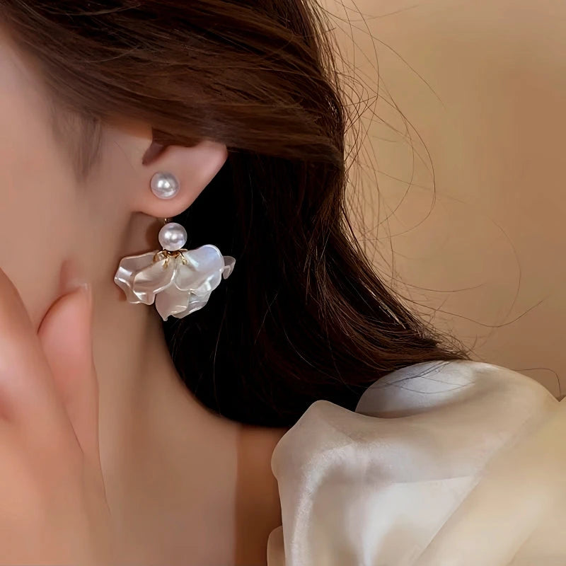 Model showcasing the dangle and style of the 14K Gold-Plated Elegant Pearl Petal Flower Earrings