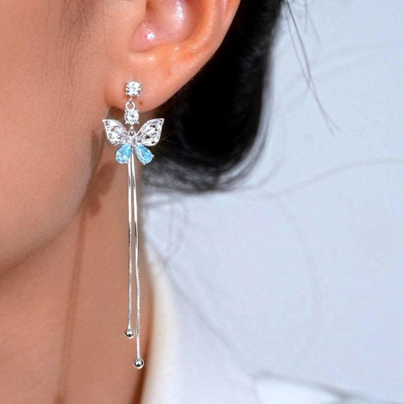 Model showcasing the dangle and style of the 14K Gold-Plated Elegant Zircon Butterlfy Tassel Earrings