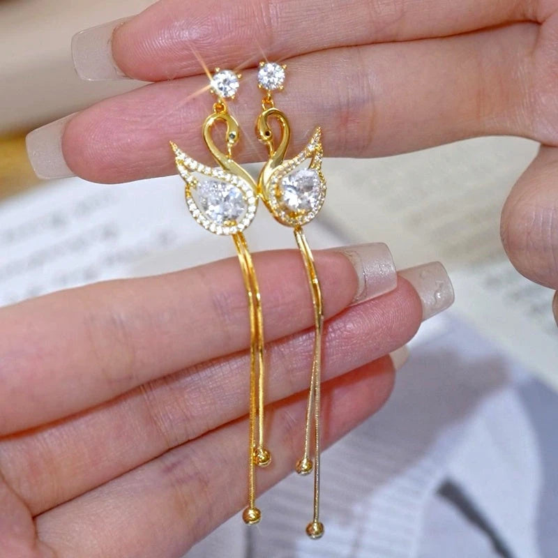 Angled view of the 14K Gold-Plated Elegant Zircon Diamond Swan Tassel Earrings