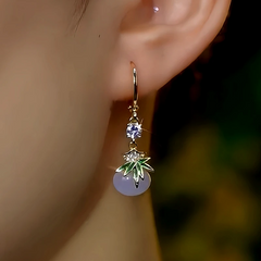 Model showcasing the dangle and style of the 14K Gold-Plated Zircon Bamboo Leaf Cat's Eye Stone Bead Earrings