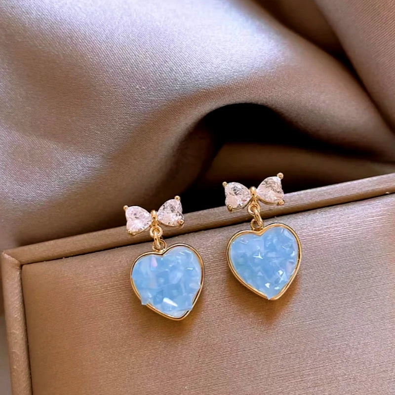 Close-up detail of the sparkling zircons and plating on the Heart Bow Earrings