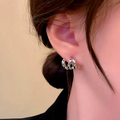 Silver twisted faux double piercing hoop earring, side view on ear