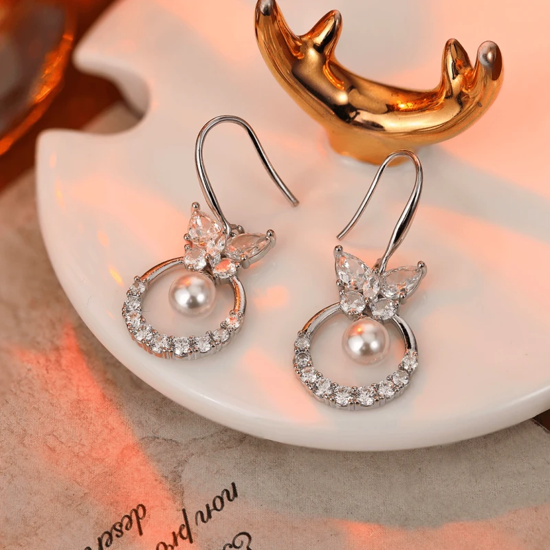 Angled view of the 14K Gold-Plated Zircon Butterfly Pearl Ear Hook Earrings