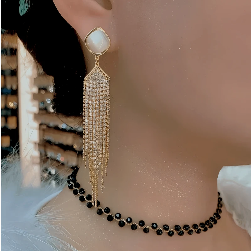 Close-up detail of the sparkling zircons and plating on the Geometric Tassel Earrings