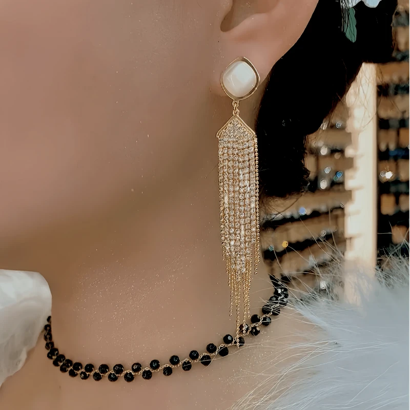 Model showcasing the dangle and style of the 14K Gold-Plated Elegant Zircon Tassel Earrings