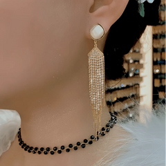 Model showcasing the dangle and style of the 14K Gold-Plated Elegant Zircon Tassel Earrings
