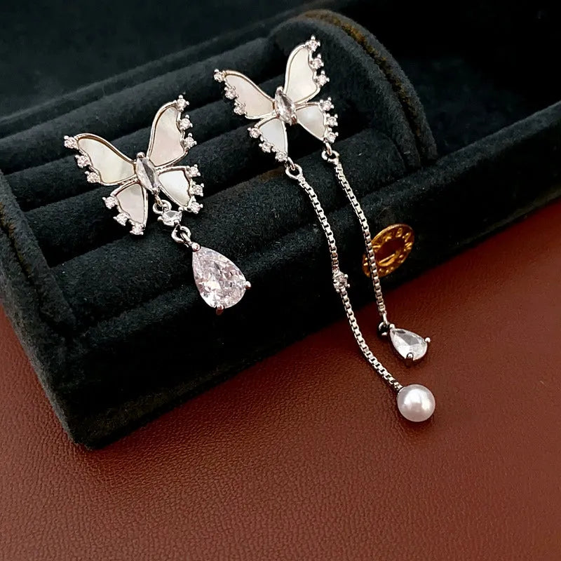 Model showcasing the dangle and style of the 14K Gold-Plated Zircon Butterfly Tassel Earrings