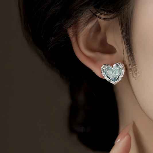 Model showcasing the dangle and style of the 14K Gold-Plated Elegant Lake Blue Heart Butterfly Stud Earrings