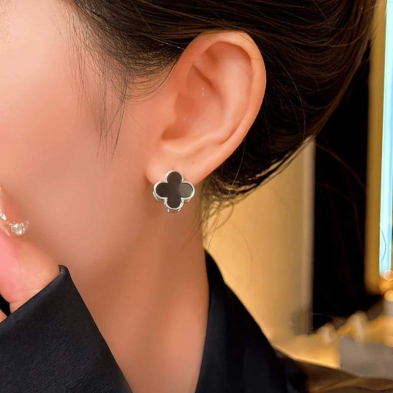 Model showcasing the dangle and style of the 14K Gold-Plated Four-Leaf Clover Double-Sided Earrings