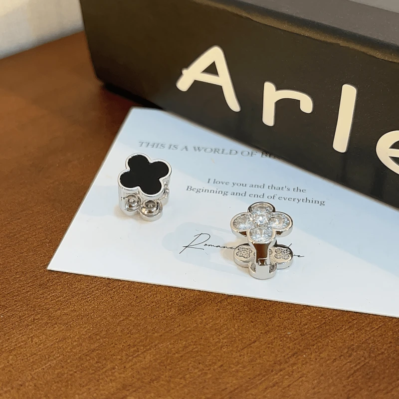 Angled view of the 14K Gold-Plated Four-Leaf Clover Double-Sided Earrings