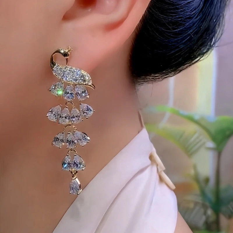 Close-up detail of the sparkling zircons and plating on the gold tassel earrings