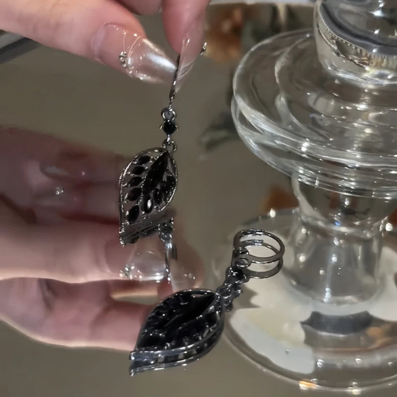 Close-up detail of the sparkling zircons and plating on the gold tassel earrings